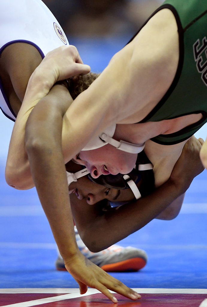 Santino Robinson of Christians Brothers College wrestles against Rock Bridge High School's Carter McCallister